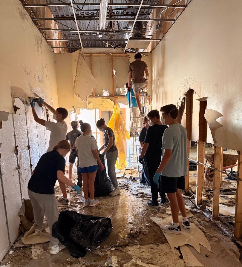 Mission volunteers working together on a building renovation