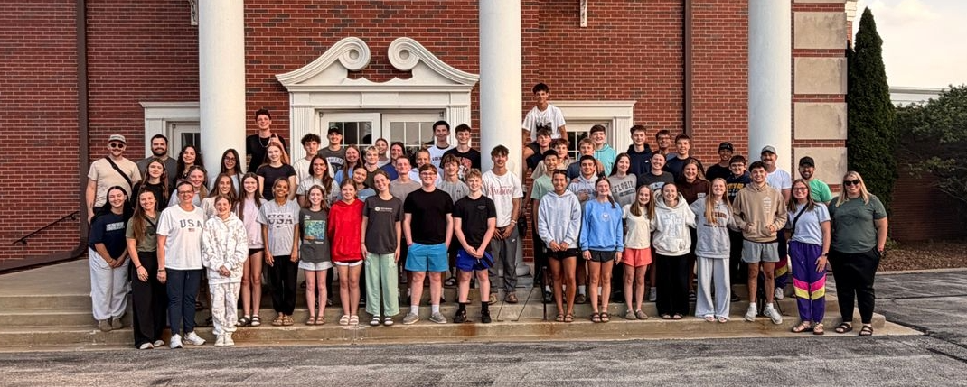 Group of mission volunteers gathered outside the church